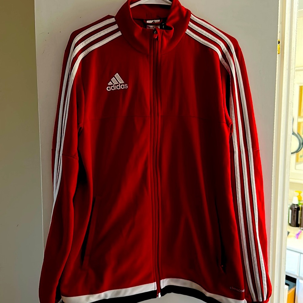 Medium men’s adidas jacket. Red with white stripes. Mesh underarms.